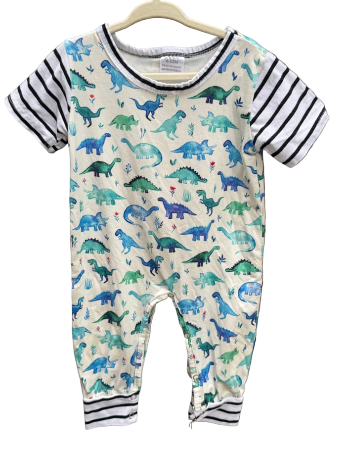 A baby short-sleeve romper hanging on a wooden hanger against a brick wall. The romper has a cream-colored body covered in a colorful dinosaur print in shades of blue, green, and teal, with black and white striped sleeves and striped leg cuffs.