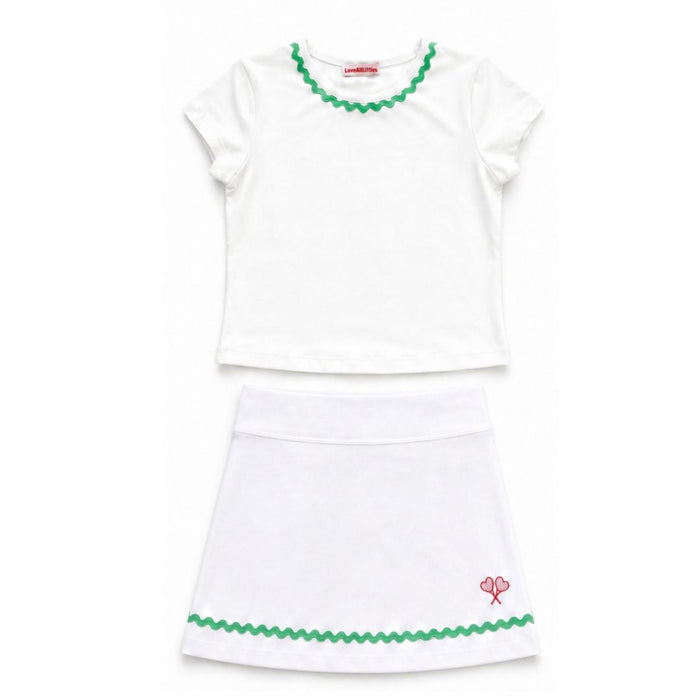 White top and skirt set with green trim on a white background