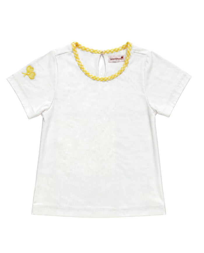 A white short-sleeve baby tee with a yellow braided trim around the crew neck and a small yellow embroidered crossed heart tennis rackets on the left sleeve, shown flat on a white background.