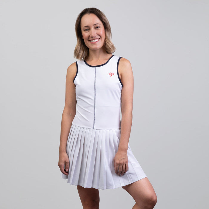 Woman wearing a white tennis dress on a gray background