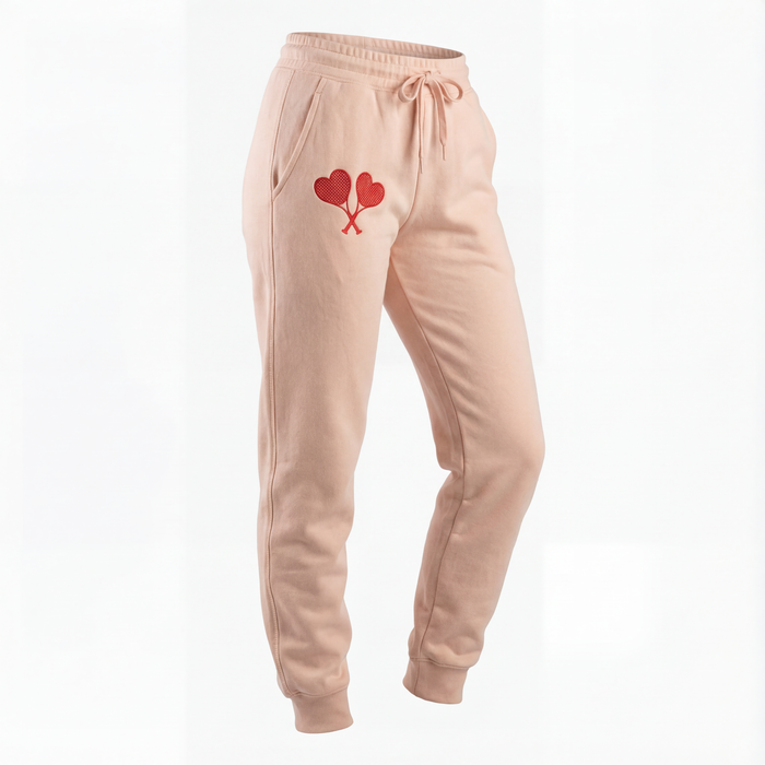 Peach sweatpants with a heart design on a white background