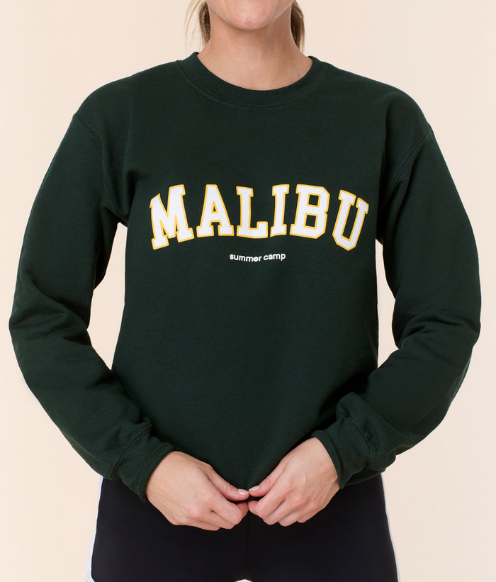 Front view of the Mindy Sweatshirt by Andie Swim in green cotton, featuring retro 'Malibu summer camp' varsity lettering