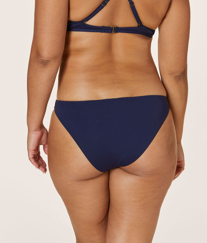 Back view of Andie Swim navy cheeky bikini bottom with medium compression, high-leg cut for a flattering fit