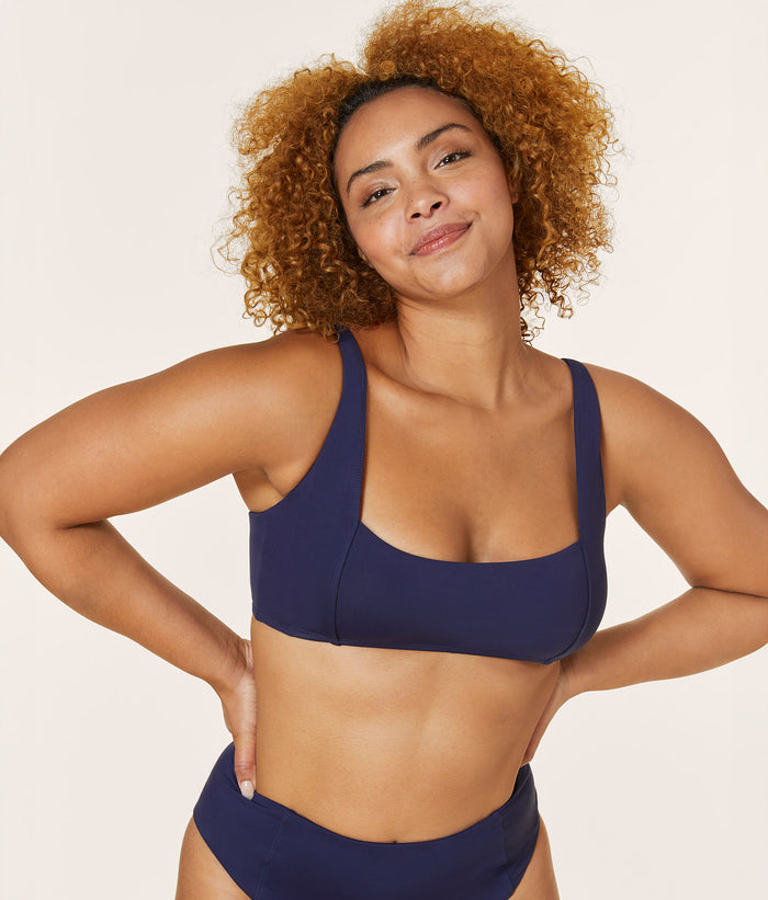 Front view of model in Andie Swim Havana Top in Navy, showcasing the low square neckline and comfortable fit with vintage-inspired style