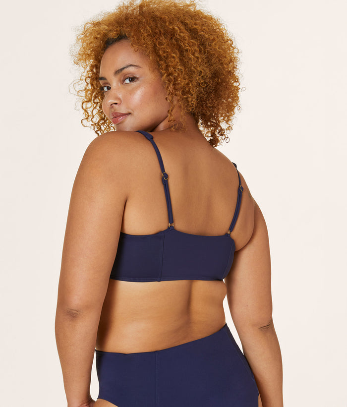 Back view of model wearing Andie Swim Havana Top in Navy, featuring adjustable straps and a flattering fit with removable soft cups