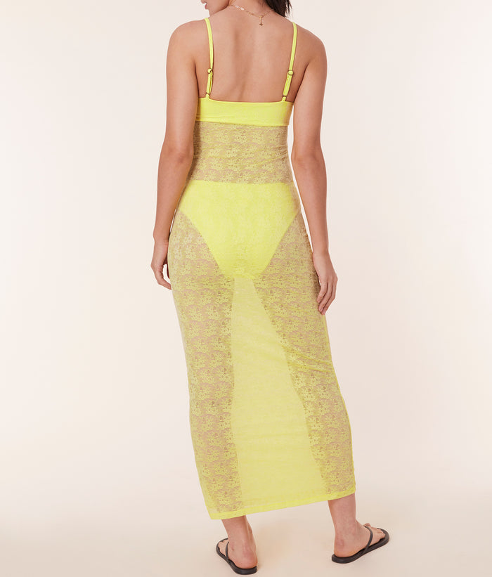 Back view of model in The Nadi Dress - Floral Lace - Limeade, showcasing the adjustable straps and sheer lace detailing.