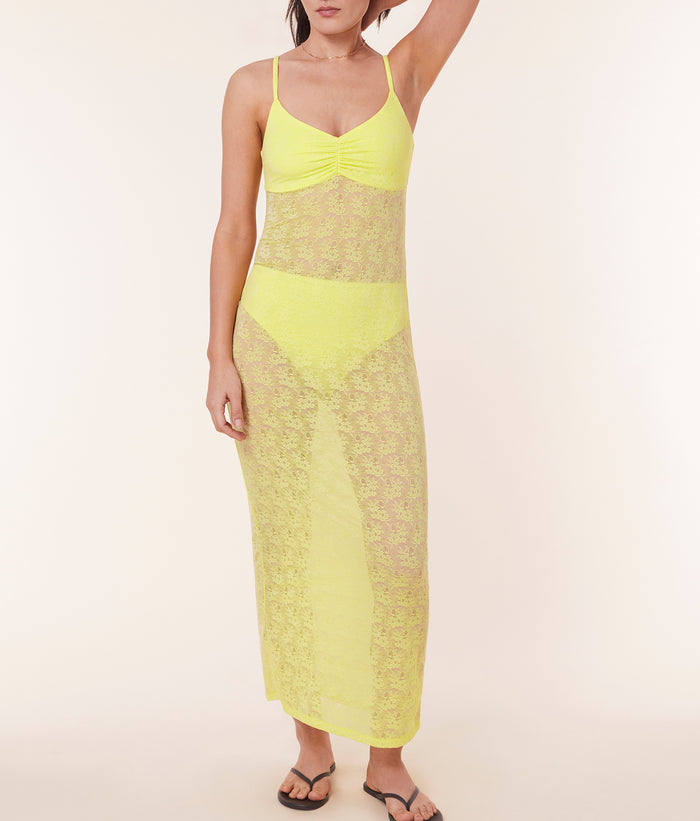 Model posing in The Nadi Dress - Floral Lace - Limeade, emphasizing the deep v-neckline and lined bust.