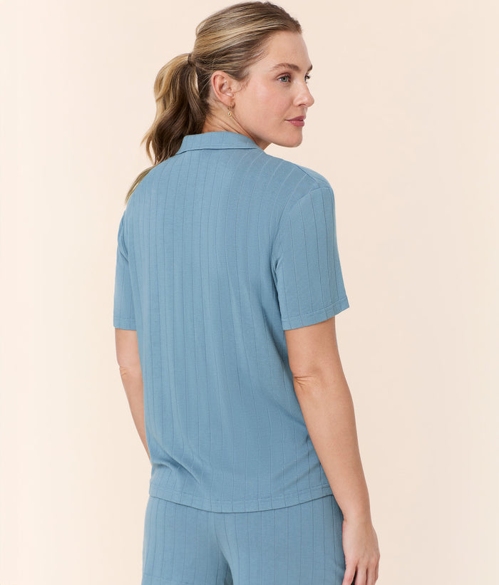 Back view of Andie Swim Short Sleeve Button Up in Infinity Blue, showcasing its comfortable, relaxed fit and soft wide rib texture