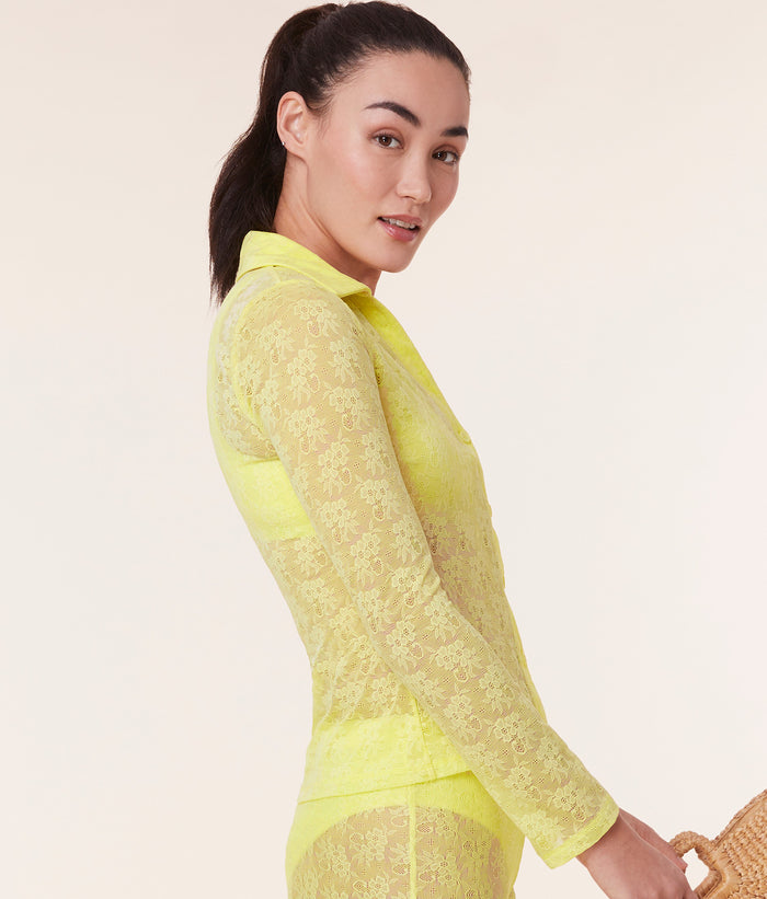 Side view of the Suva Top in Limeade by Andie Swim, showcasing the fitted silhouette and sheer floral lace fabric