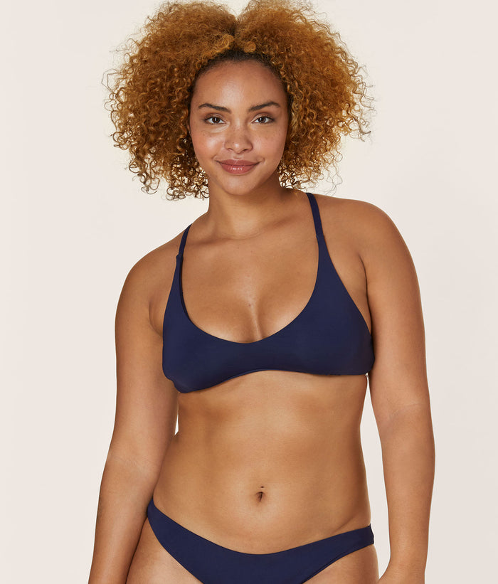 Front view of a model wearing The Valencia Top - Flat - Navy, displaying the medium bust support and classic design.