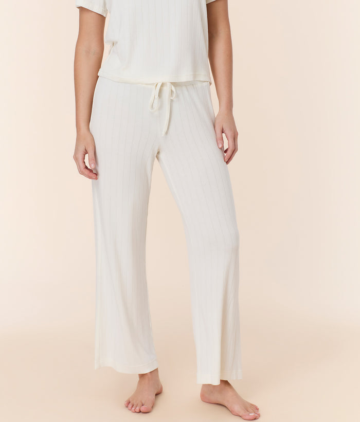 Front view of snow white wide leg pant by Andie Swim, high-rise fit and adjustable elastic waistband styled on model.