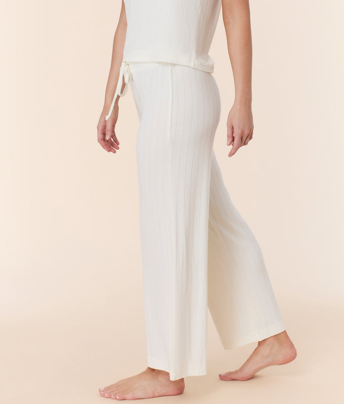 Side view of snow white wide leg pant by Andie Swim, featuring high-rise fit and relaxed wide leg style on model